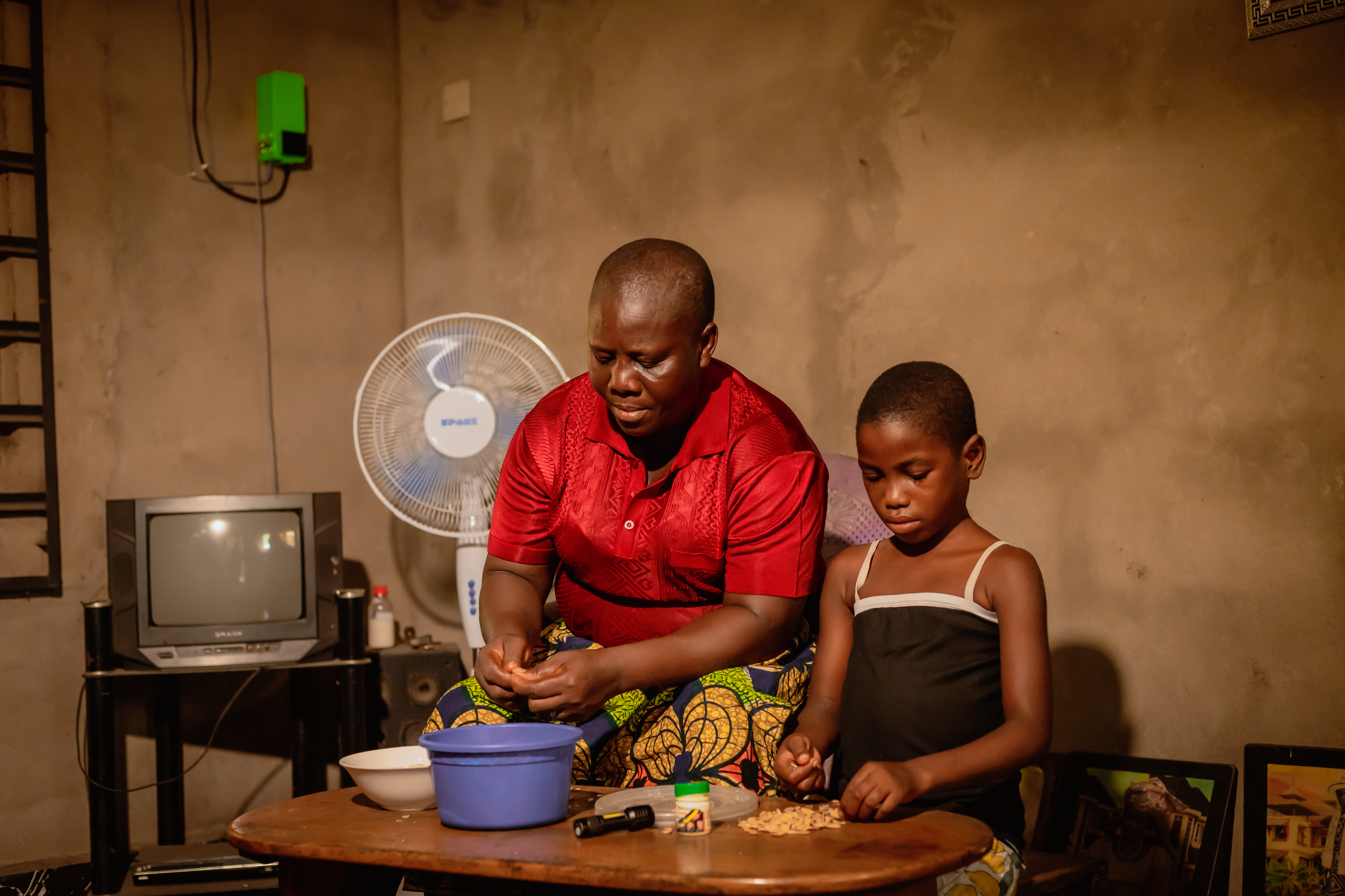 One of the solar Home System SHS Beneficiaries under DARES project from Akwa ibom State, Mrs. Mercy Patrick and her child.